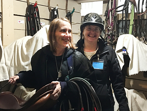 2 women in a tac room at horse stable