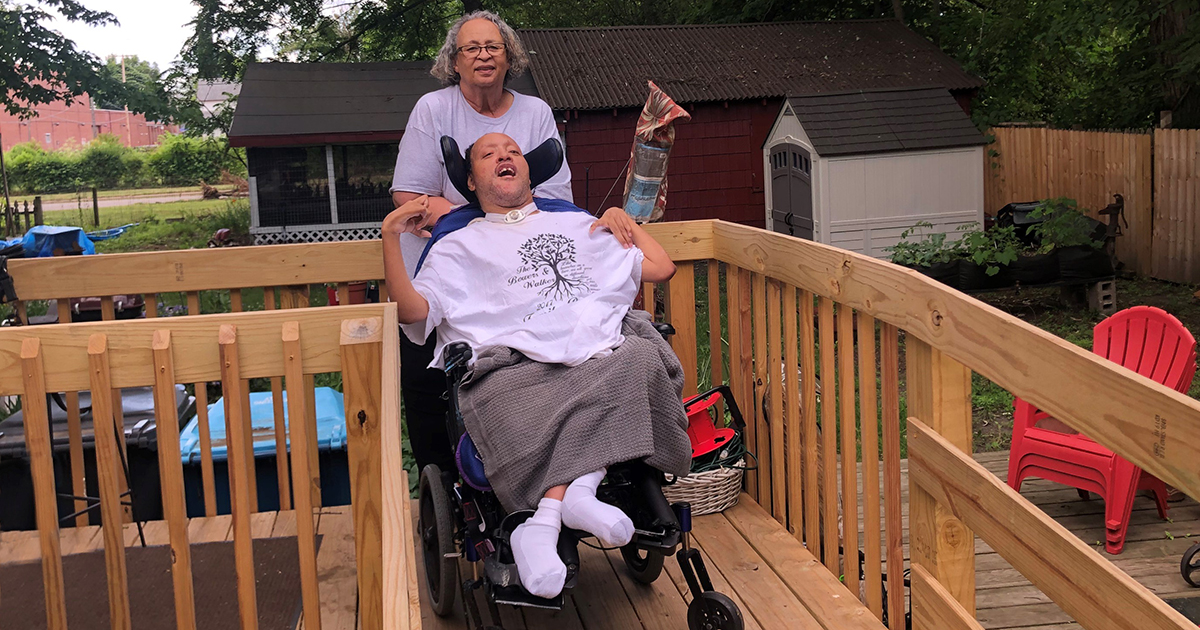 Man in wheelchair with his mom on new ramp