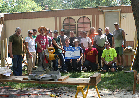 volunteers posing at ramp construction site
