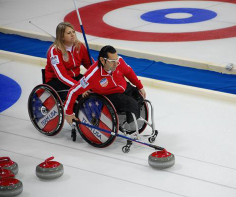 man and women in wheelchairs curling