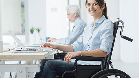 young woman in wheelchair at a computer