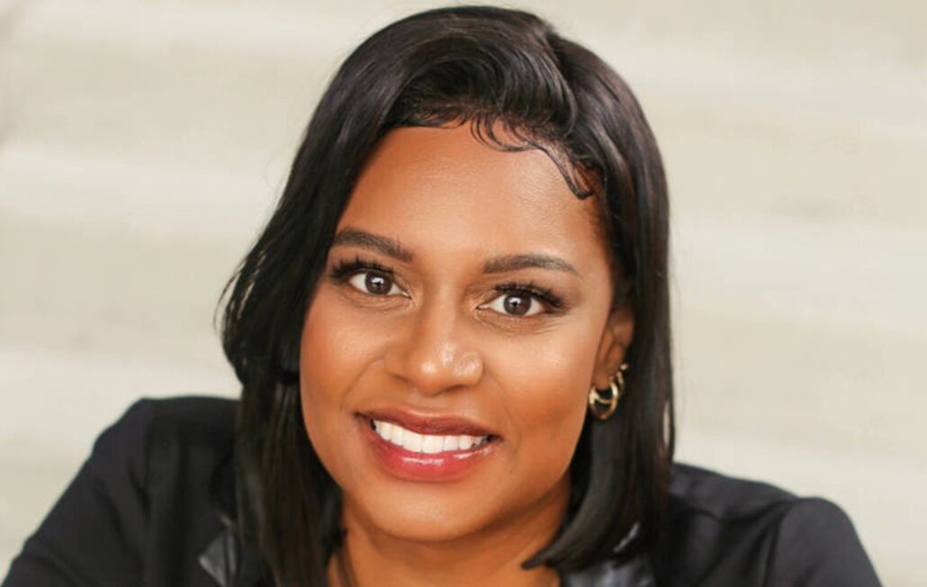 A Black woman with shoulder length hair wearing a black blazer.