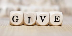 Image of four blocks with the word GIVE.