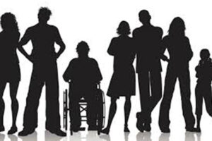 People in a group including a person using a wheelchair.